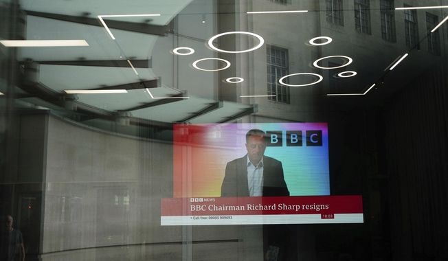 A screen showing a news report through the windows of the BBC, after chairman Richard Sharp announced he was quitting as BBC chairman, in London, Friday April 28, 2023. The chairman of the BBC has resigned after a report found he breached the government rules governing public appointments. The publicly funded national broadcaster has been under pressure after it was revealed that Sharp, a Conservative Party donor helped arrange a loan for then-Prime Minister Boris Johnson in 2021, weeks before he was appointed to the BBC post on the government’s recommendation. (Jordan Pettitt/PA via AP)