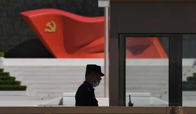 A security guard stands near a sculpture of the Chinese Communist Party flag at the Museum of the Communist Party of China on May 26, 2022, in Beijing. China’s military flew 38 fighter jets and other warplanes near Taiwan, the Taiwanese defense ministry said Friday, April 28, 2023, in the largest such flight display since the large military exercise in which it simulated sealing off the island earlier in the month. (AP Photo/Ng Han Guan) **FILE**