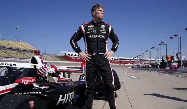 Josef Newgarden stands next to his car after qualifying for an IndyCar Series auto race, Saturday, July 23, 2022, at Iowa Speedway in Newton, Iowa. The first episode of “100 Days to Indy” featured a behind the scenes look at the IndyCar series, personalities and even a shirtless star Josef Newgarden. (AP Photo/Charlie Neibergall, File)