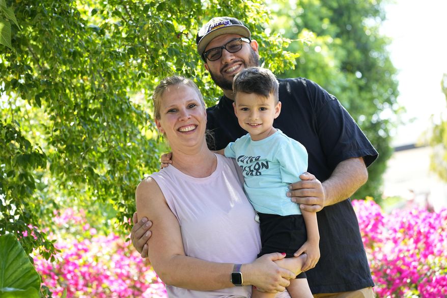 Alicia Celaya, David Cardenas and their son Adrian, 3, are shown at their home, Thursday, April 27, 2023, in Phoenix. Celaya and her family will lose their Medicaid coverage later this year, a result of a yearlong nationwide review of the 84 million Medicaid enrollees that will require states to remove people whose incomes are now too high for the program. Advocacy groups say beneficiaries are finding the process confusing and at times riddled with errors, leaving some of the country's poorest people suddenly without health insurance and unable to pay for necessary medical care. (AP Photo/Matt York)