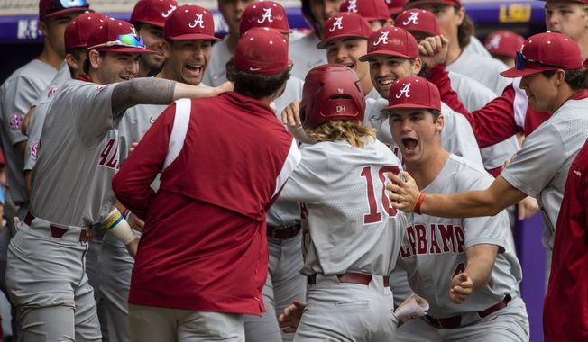 Alabama&#x27;s Jim Jarvis (10) is mobbed by teammates after hitting the first-inning home run against LSU in an NCAA college baseball game Saturday, April 29, 2023, in Baton Rouge, La. (Michael Johnson/The Advocate via AP)