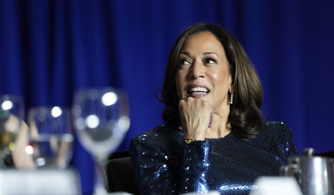 Vice President Kamala Harris listens as Comedian Roy Wood Jr., a correspondent for &quot;The Daily Show,&quot; speaks during the White House Correspondents&#x27; Association dinner at the Washington Hilton in Washington, Saturday, April 29, 2023. (AP Photo/Carolyn Kaster)