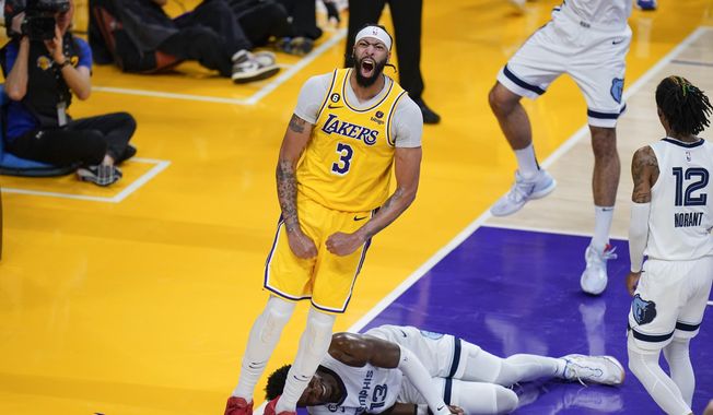 Los Angeles Lakers&#x27; Anthony Davis (3) celebrates his dunk as Memphis Grizzlies&#x27; Jaren Jackson Jr. (13) falls to the court during the second half in Game 6 of a first-round NBA basketball playoff series Friday, April 28, 2023, in Los Angeles. (AP Photo/Jae C. Hong)