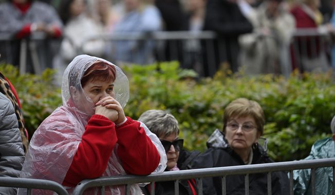 People wait Pope Francis outside the St. Elizabeth of Hungary Church in Budapest, Hungary, Saturday, April 29, 2023. The Pontiff is in Hungary for a three-day pastoral visit. (AP Photo/Denes Erdos)
