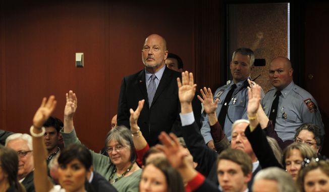 D.A. King, who spoke in favor of HB59, looks on as people raise their hands to show their disapproval of the measure during a meeting of the House Higher Education Committee Tuesday, Jan. 31, 2012, in Atlanta. The committee is set to discussed  HB59 that would bar illegal immigrants from all Georgia state colleges and universities. The bill passed out of committee last year, but never made it to the full House for a vote. (AP Photo/John Bazemore) ** FILE **