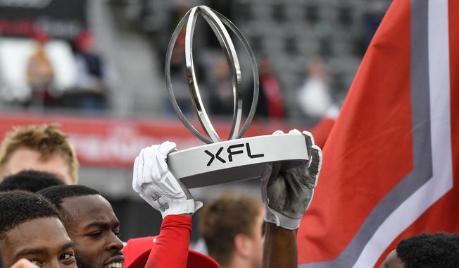 The XFL North Division Championship trophy being held up high after the Defenders victory over the Seattle Sea Dragons at Audi Field in Washington D.C., April 30, 2023. (Photo by Billy Sabatini)