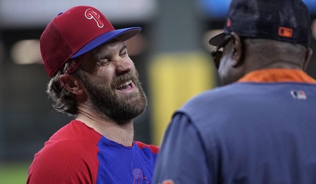 Philadelphia Phillies&#x27; Bryce Harper, left, laughs with talking with Houston Astros manager Dusty Baker Jr. before a baseball game Saturday, April 29, 2023, in Houston. (AP Photo/David J. Phillip) **FILE**