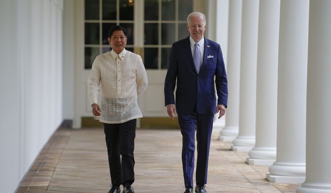 President Joe Biden and Philippines President Ferdinand Marcos Jr. walk on the West Colonnade to the Oval Office following a welcome ceremony at the White House in Washington, Monday, May 1, 2023. (AP Photo/Carolyn Kaster, Pool)