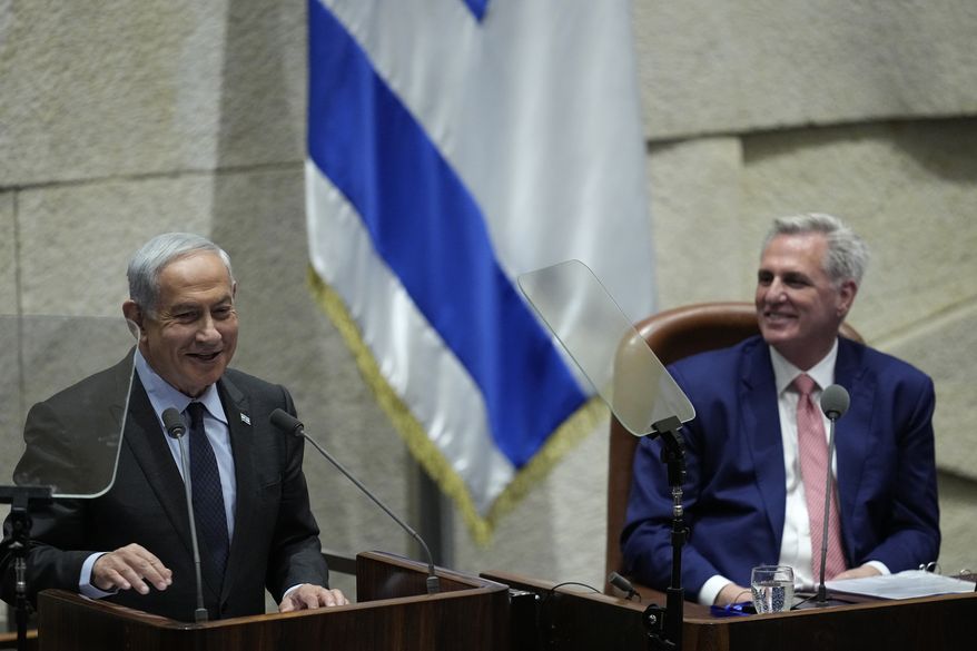 Israeli Prime Minister Benjamin Netanyahu, left, speaks as U.S. Speaker of the House Kevin McCarthy, right, reacts during a session of the Knesset, Israel's parliament in Jerusalem, Monday, May 1, 2023. (AP Photo/Ohad Zwigenberg)