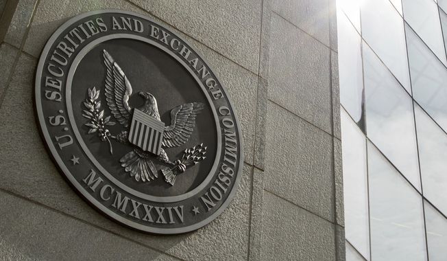 The seal of the U.S. Securities and Exchange Commission at SEC headquarters in Washington is seen, June 19, 2015. A bipartisan group of more than a two dozen lawmakers are asking the SEC to put the brakes on an initial public offering by Chinese fast fashion retailer Shein until it verifies it does not use forced labor from the countrys predominantly Muslim Uyghur population. (AP Photo/Andrew Harnik, File)