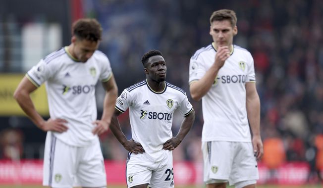 Leeds United&#x27;s Wilfried Gnonto, center, looks dejected following their defeat in the English Premier League soccer match between Bournemouth and Leeds United at the Vitality Stadium, Bournemouth, England, Sunday April 30, 2023. (Steven Paston/PA via AP)