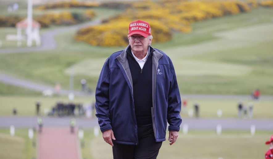Former US president Donald Trump, center, at Turnberry golf course, Scotland, during his visit to the UK, Tuesday May 2, 2023. (Steve Welsh/PA via AP)