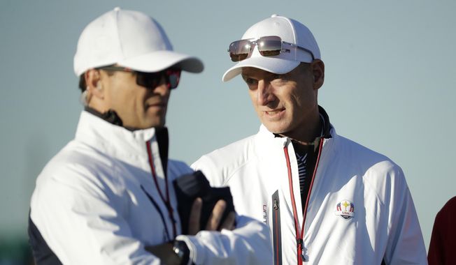 U.S. team captain Jim Furyk, right, stands alongside vice-captain Zach Johnson on the driving range at Le Golf National in Guyancourt, outside Paris, France, Tuesday, Sept. 25, 2018. Furyk has been named U.S. captain for the 2024 Presidents Cup at Royal Montreal. (AP Photo/Matt Dunham, File)