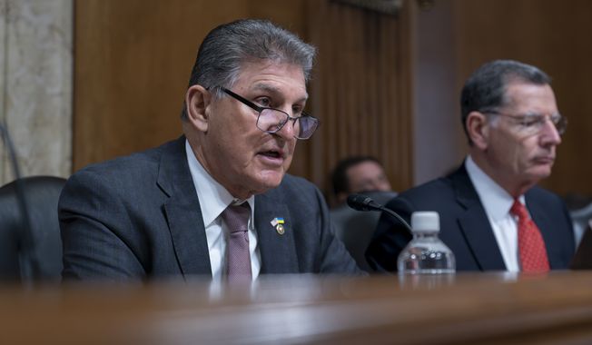 Sen. Joe Manchin, D-W.Va., left, chair of the Senate Energy and Natural Resources Committee, is joined by Sen. John Barrasso, R-Wyo., the ranking member, as the panel hears from Interior Secretary Deb Haaland on President Joe Biden&#x27;s budget request for 2024, at the Capitol in Washington, Tuesday, May 2, 2023. (AP Photo/J. Scott Applewhite)