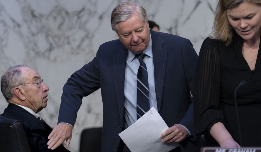 Sen. Chuck Grassley, R-Iowa, left, is greeted by Sen. Lindsey Graham, R-S.C., the ranking member of the Senate Judiciary Committee, as the panel holds a hearing in response to recent criticism of the ethical practices of some justices of the Supreme Court, at the Capitol in Washington, Tuesday, May 2, 2023. Associate Justice Clarence Thomas has been criticized for accepting luxury trips nearly every year for more than two decades from Republican megadonor Harlan Crow without reporting them on financial disclosure forms. (AP Photo/J. Scott Applewhite) **FILE**