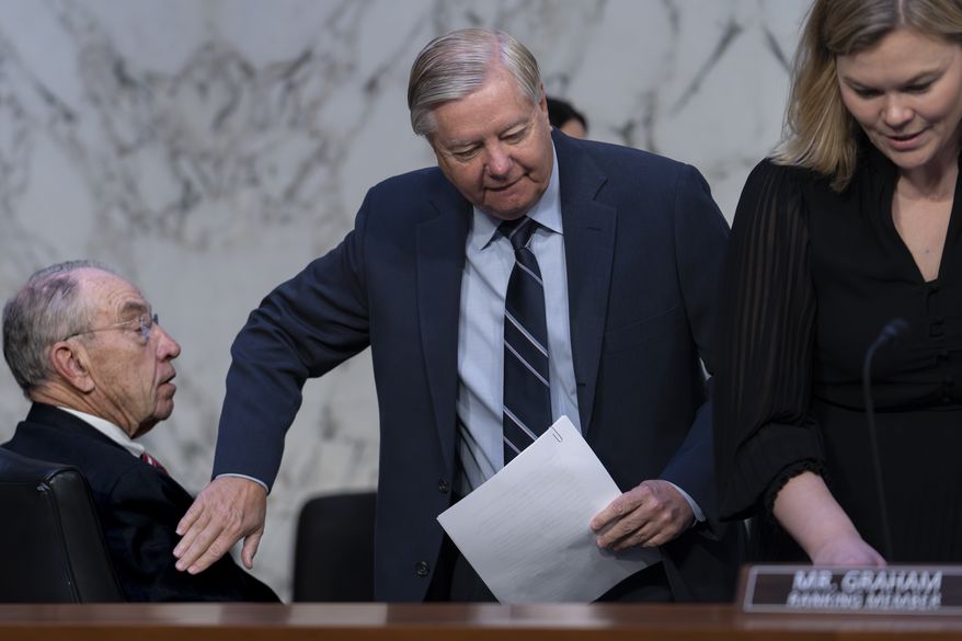 Sen. Chuck Grassley, R-Iowa, left, is greeted by Sen. Lindsey Graham, R-S.C., the ranking member of the Senate Judiciary Committee, as the panel holds a hearing in response to recent criticism of the ethical practices of some justices of the Supreme Court, at the Capitol in Washington, Tuesday, May 2, 2023. Associate Justice Clarence Thomas has been criticized for accepting luxury trips nearly every year for more than two decades from Republican megadonor Harlan Crow without reporting them on financial disclosure forms. (AP Photo/J. Scott Applewhite) **FILE**