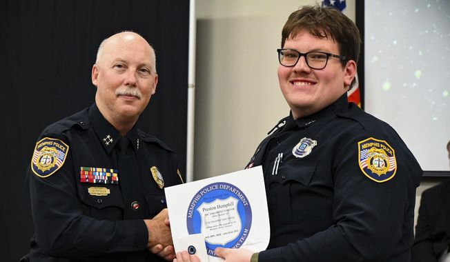 In this photo obtained from the Memphis, Tenn., Police Department&#x27;s Facebook page, Preston Hemphill, right, receives a certificate from Memphis Assistant Chief of Police Don Crowe, left, after completing the training to join the department&#x27;s Crisis Intervention Team on July 21, 2022. Hemphill, the Memphis police officer who hit Nichols with a stun gun during a traffic stop that preceded Nichols’ brutal beating by other officers, won&#x27;t be charged criminally, a prosecutor said on Tuesday, May 2, 2023. (Memphis Police Department via AP, File)