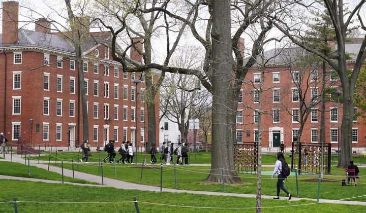 Students walk through Harvard Yard on the campus of Harvard University in Cambridge, Mass., on April 27, 2022. (AP Photo/Charles Krupa) ** FILE **