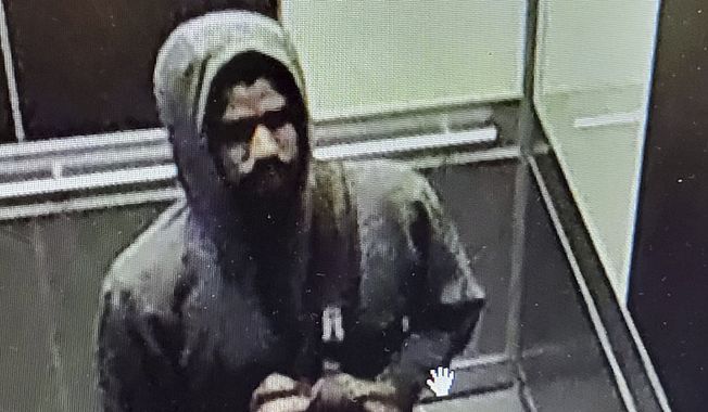 This photo released by the Atlanta Police Department of video footage on Wednesday, May 3, 2023, shows a suspected shooter. Police said Wednesday afternoon that they were investigating an active shooter situation in a building in Atlanta&#x27;s Midtown neighborhood and that multiple people had been injured. (Atlanta Police Department via AP)
