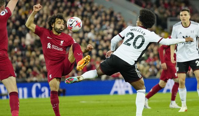 Liverpool&#x27;s Mohamed Salah, left, challenges for the ball with Fulham&#x27;s Willian during the English Premier League soccer match between Liverpool and Fulham, at Anfield Stadium, Liverpool, England, Wednesday, May 3, 2023. (AP Photo/Jon Super)