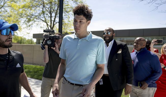 Jackson Mahomes, center, exits the Johnson County jail after being arraigned on three charges of sexual battery on Wednesday, May 3, 2023, in Olathe, Kan. (Nick Wagner/The Kansas City Star via AP)