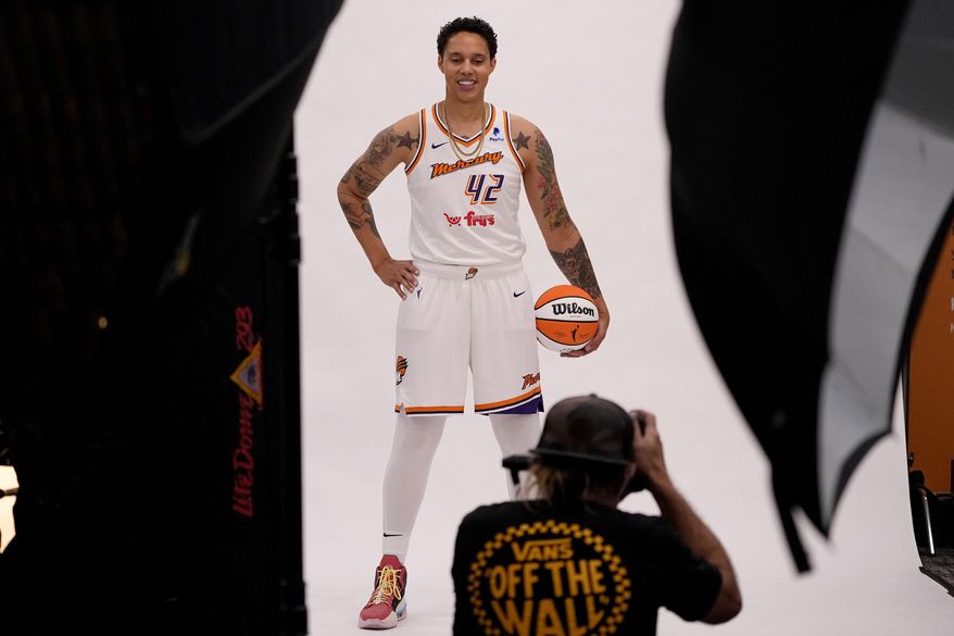 Phoenix Mercury team photographer Barry Gossage takes a photo of Phoenix Mercury center Brittney Griner during the WNBA basketball teams' media day, Wednesday, May 3, 2023, in Phoenix. (AP Photo/Matt York)