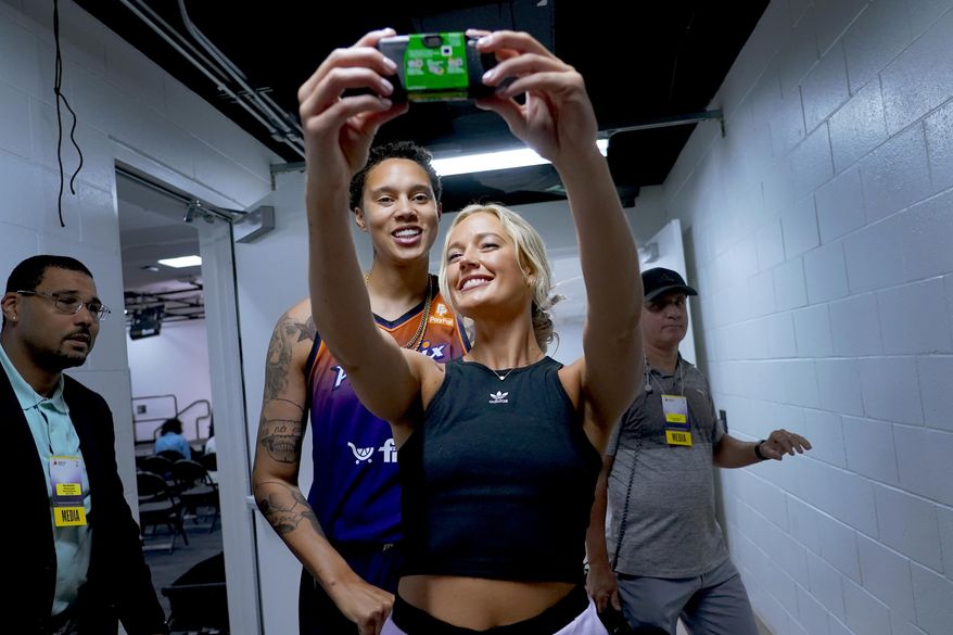 Phoenix Mercury guard Sophie Cunningham takes a selfie with Phoenix Mercury center Brittney Griner, left, during the WNBA basketball teams' media day, Wednesday, May 3, 2023, in Phoenix. (AP Photo/Matt York)