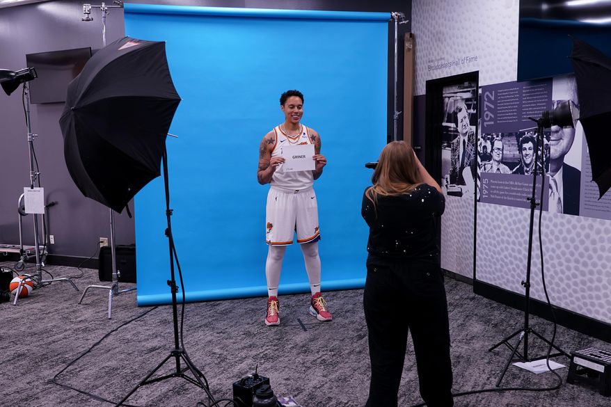 WNBA photographer Kate Frese photographs Phoenix Mercury center Brittney Griner during the WNBA basketball teams' media day, Wednesday, May 3, 2023, in Phoenix. (AP Photo/Matt York)