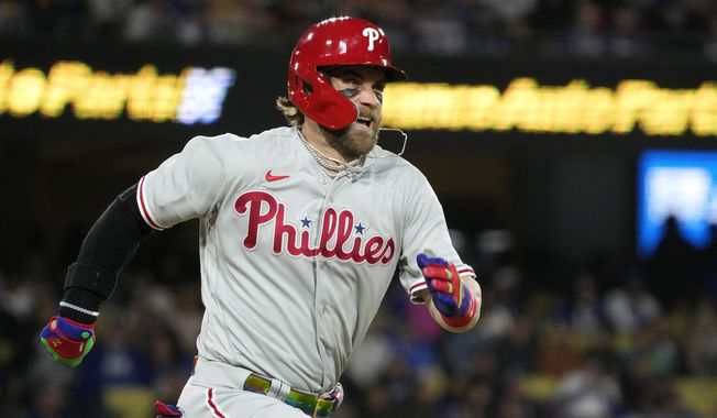 Philadelphia Phillies&#x27; Bryce Harper heads to first as he grounds out during the fourth inning of a baseball game against the Los Angeles Dodgers Tuesday, May 2, 2023, in Los Angeles. (AP Photo/Mark J. Terrill)