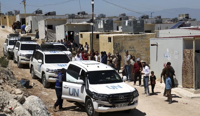 A UN convoy arrives at a camp in Idlib province, Syria, Wednesday, May 3, 2023. Three months after a massive earthquake hit Turkey and Syria, living conditions remain dire in Syria&#x27;s rebel-held northwest. Three U.N. officials who visited Syria&#x27;s Idlib province on Wednesday said some progress has been made but still more needs to be done to help the population in the rebel-held northwest that is home to some 4 million people. (AP Photo/Omar Albam)