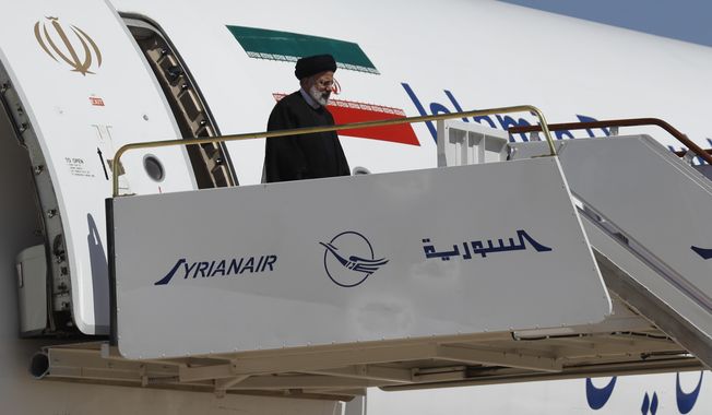 Iranian President Ebrahim Raisi steps off the plane as he arrives to the airport in Damascus, Syria, Wednesday, May 3, 2023. It is the first visit by an Iranian head of state to war-torn Syria since the beginning of the country&#x27;s uprising-turned-civil-war in 2011, in which Tehran helped tip the balance of power to the government. (AP Photo/Omar Sanadiki)