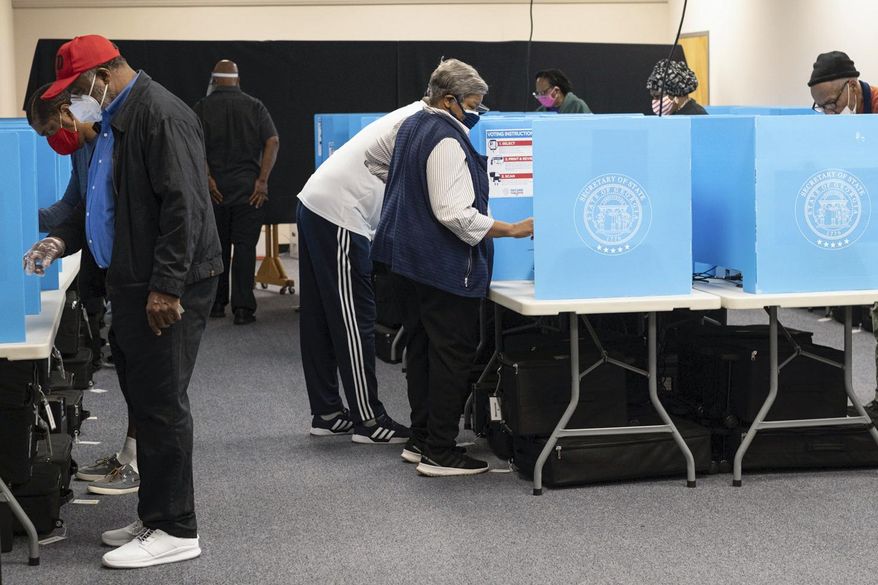 Voters make their selections as early voting starts on Oct. 12, 2020, in Decatur, Ga. Gov. Brian Kemp on Wednesday, May, 3, 2023, signed a law banning local governments from accepting any funding for elections from outside groups except the state or federal governments. (Ben Gray/Atlanta Journal-Constitution via AP, File)