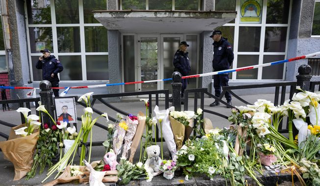 Police officers guard the Vladimir Ribnikar school in Belgrade, Serbia, Thursday, May 4, 2023. A 13-year-old who opened fire Wednesday at his school in Serbia&#x27;s capital killed eight fellow students and a guard before calling the police and being arrested. Six children and a teacher were also hospitalized. (AP Photo/Darko Vojinovic)