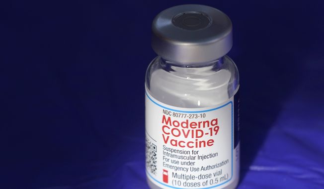 In this March 4, 2021 file photo, a vial of the Moderna COVID-19 vaccine rests on a table at a drive-up mass vaccination site in Puyallup, Wash., south of Seattle. Moderna reports their earnings on Thursday, May 4, 2023. (AP Photo/Ted S. Warren, File)