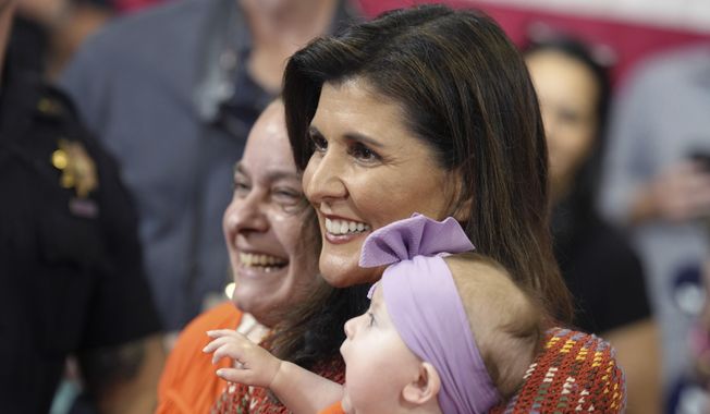 Republican presidential contender Nikki Haley, center, smiles with a woman and a baby after speaking at a campaign rally on Thursday, May 4, 2023, in Greer, S.C. The former South Carolina governor and U.N. ambassador launched her presidential campaign in February. (AP Photo/Meg Kinnard)