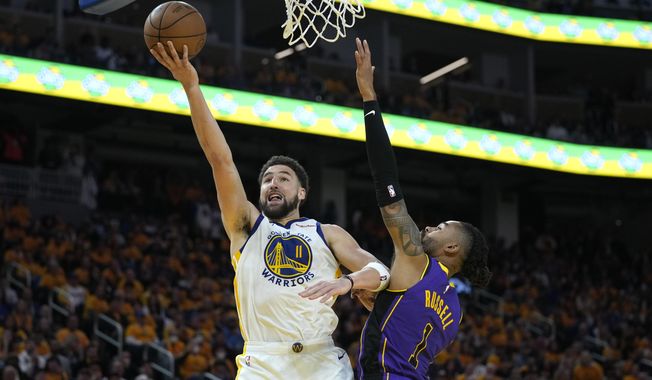 Golden State Warriors guard Klay Thompson (11) shoots against Los Angeles Lakers guard D&#x27;Angelo Russell, right, during the second half of Game 2 of an NBA basketball Western Conference semifinal game, Thursday, May 4, 2023, in San Francisco. (AP Photo/Godofredo A. Vásquez)