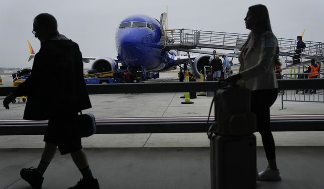 Travelers deplane a Southwest Airlines flight on Wednesday, May 26, 2023, in Long Beach, Calif. (AP Photo/Ashley Landis) ** FILE **
