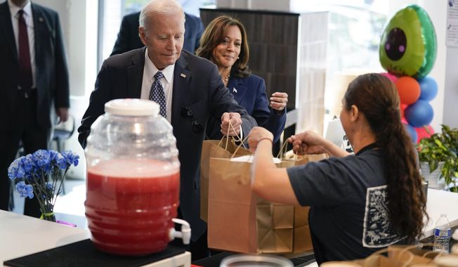 President Joe Biden and Vice President Kamala Harris pick up food from Taqueria Habanero, Friday, May 5, 2023, in Washington. (AP Photo/Evan Vucci)