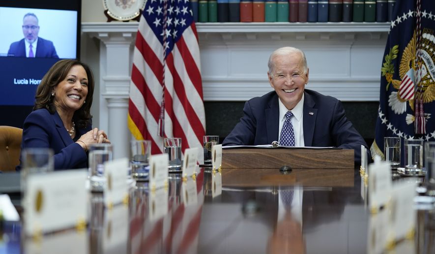 President Joe Biden and Vice President Kamala Harris smile during a meeting with his &quot;Investing in America Cabinet,&quot; in the Roosevelt Room of the White House, Friday, May 5, 2023, in Washington. Education Secretary Miguel Cardona appears on a screen as he attends the meeting virtually. (AP Photo/Evan Vucci)