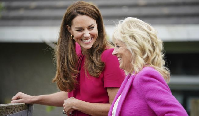 Britain&#x27;s Kate, Duchess of Cambridge, left, and first lady Jill Biden laugh during a visit to Connor Downs Academy in Hayle, West Cornwall, during the G7 summit in England, June 11, 2021. The first lady will be back in London for another royal engagement. President Joe Biden sent his wife to represent the United States at Saturday&#x27;s coronation of King Charles III. (Aaron Chown/Pool photo via AP, File)
