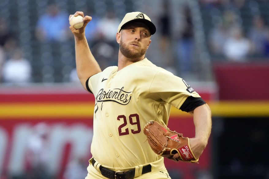 Arizona Diamondbacks pitcher Merrill Kelly throws against the Washington Nationals in the first inning during a baseball game, Friday, May 5, 2023, in Phoenix. (AP Photo/Rick Scuteri)
