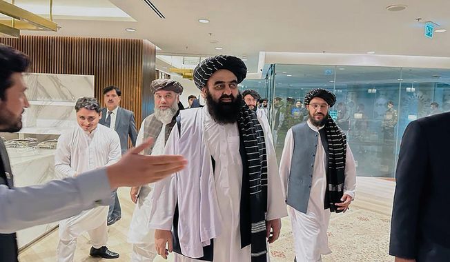 In this photo provided by Afghanistan Embassy in Pakistan, the Taliban-appointed Foreign Minister Amir Khan Muttaqi, center, walks with other officials upon his arrival in airport, in Islamabad, Pakistan, Friday, May 5, 2023. Muttaqi arrived in Islamabad on Friday to attend a meeting. The three-way meeting on Saturday is also seen as an outreach to the Taliban by Pakistan, who has acted as a mediator with Afghanistan&#x27;s new rulers, and China, which is eager to expand its influence in the region. (Afghanistan Embassy in Pakistan via AP)
