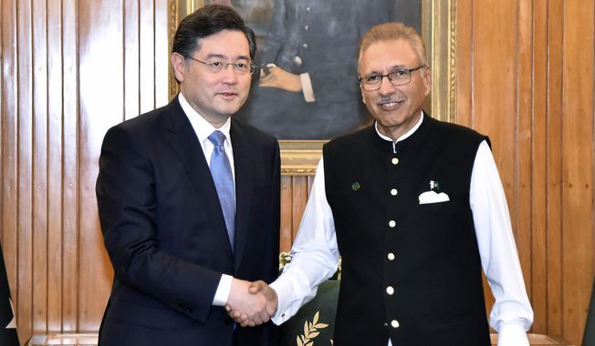 In this photo released by Pakistan&#x27;s President office, visiting Chinese Foreign Minister Qin Gang, left, shakes hand with Pakistani President Arif Alvi prior to their meeting, in Islamabad, Pakistan, Friday, May 5, 2023. The Pakistani president on Friday assured Beijing&#x27;s top diplomat that his country will boost security for all Chinese nationals working on multi-billion dollar projects in cash-strapped Pakistan. (Pakistan President Office via AP)