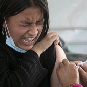A girl reacts as she receives a shot of the Pfizer-BioNTech vaccine for COVID-19 in Kathmandu, Nepal, Tuesday, Nov. 23, 2021. Children above the age of 12 are now receiving the vaccine in Nepal. The World Health Organization downgraded its assessment of the coronavirus pandemic on Friday, May 5, 2023, saying it no longer qualifies as a global emergency. (AP Photo/Niranjan Shrestha, File)