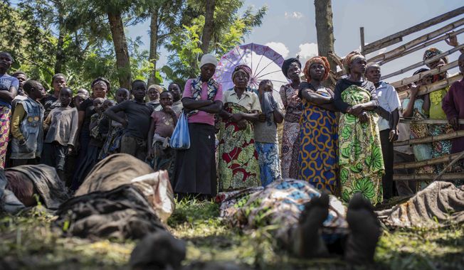 Relatives gather to identify bodies in the village of Nyamukubi, South Kivu province, Congo, Saturday, May 6, 2023. The death toll from flash floods and landslides in eastern Congo has risen to over 150, with some 100 people still missing, according to a provisional assessment given by the governor and authorities in the country&#x27;s South Kivu province. (AP Photo/Moses Sawasawa)