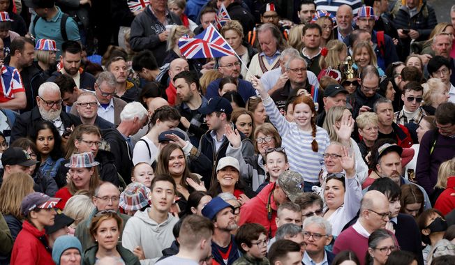 People gather ahead of the Coronation of Britain&#x27;s King Charles III in London, Saturday, May 6, 2023. (Piroschka van de Wouw/Pool via AP)