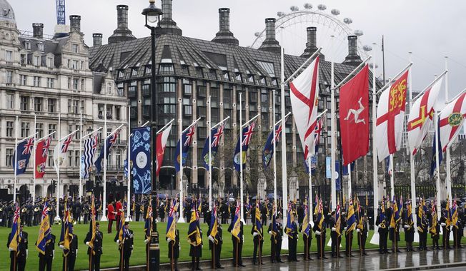 Standard bearers and members of the military in Parliament Square, ahead of the coronation ceremony of King Charles III at Westminster Abbey, London, Saturday, May 6, 2023. (Jane Barlow/Pool Photo via AP)