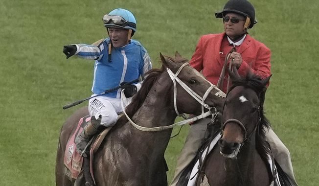 Javier Castellano celebrates after riding Mage to win the 149th running of the Kentucky Derby horse race at Churchill Downs Saturday, May 6, 2023, in Louisville, Ky. (AP Photo/Charlie Riedel)
