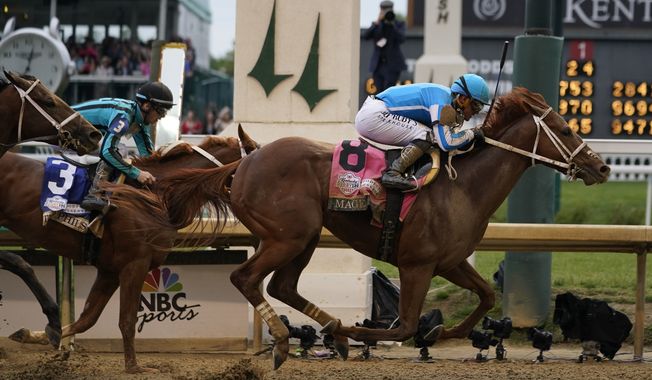 Mage (8), with Javier Castellano aboard, across the finish line to win the 149th running of the Kentucky Derby horse race at Churchill Downs Saturday, May 6, 2023, in Louisville, Ky. (AP Photo/Kiichiro Sato)