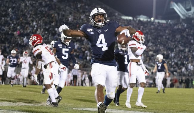 Penn State running back Journey Brown (4) celebrates his third quarter touchdown run against Rutgers during an NCAA college football game in State College, Pa, Nov. 30, 2019. Brown thought he was headed for an NFL career after starring as a running back at Penn State, but now after a heart condition diagnosis, he is working towards a career as a NASCAR pit crew. (AP Photo/Barry Reeger, File)